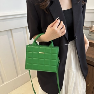 Chic vibrant green quilted crossbody bag with golden metal detail and elegant handle