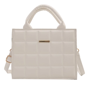 White quilted tote bag with gold metal trim and adjustable shoulder strap for women