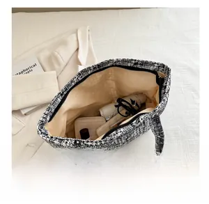 Internal view of plaid tote bag showing spacious capacity for wallet and essentials