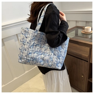 Detail of blue and white plaid tweed tote bag with textured vintage woven fabric