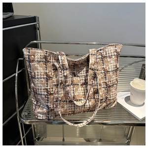 Detail view of large capacity plaid tote bag in brown and white tweed with dual straps
