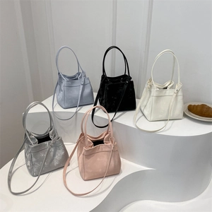 Minimalist velvet bucket bags in five colors with slim handles and shoulder straps