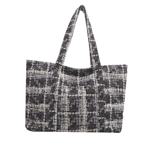 Classic black and white checkered tote bag with wide handles for shoulder or hand carry
