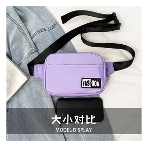 Size comparison of a purple nylon waist bag next to a 6-inch black smartphone
