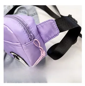 Detail of purple nylon waist bag featuring smooth zipper and pink woven cord puller