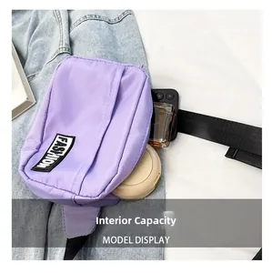 Detail view of purple nylon crossbody bag showing spacious internal capacity and storage