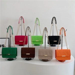 Chic quilted crossbody chain bags in eight colors displayed on white pedestals