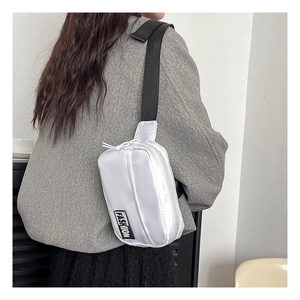 Detail of white matte nylon crossbody bag with black fashion label on model