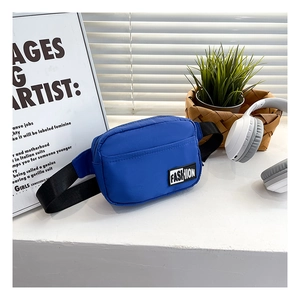 Close-up of blue nylon crossbody bag with fashion label on a stylish urban background
