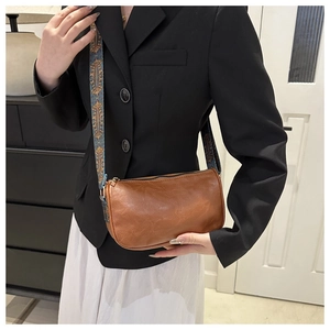 Brown vintage baguette bag with bohemian jacquard strap and polished metal zipper detail