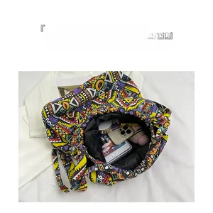 Top view of spacious canvas tote interior showing phone, umbrella and cosmetics storage
