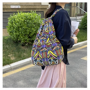Detail of colorful geometric canvas drawstring bag with side pocket and ethnic pattern