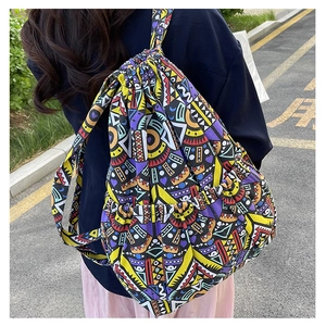 Detailed view of colorful geometric pattern canvas drawstring backpack on a model