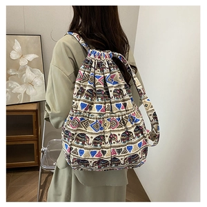 Detail of bohemian canvas drawstring backpack with colorful elephant and geometric patterns