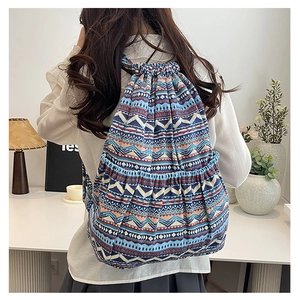 Detail of canvas drawstring backpack with ethnic geometric pattern and large front pocket