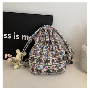Detailed view of ethnic elephant print canvas bucket bag with drawstring closure