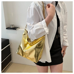 Detail of metallic gold bucket bag showing shiny leather texture and chain strap detail