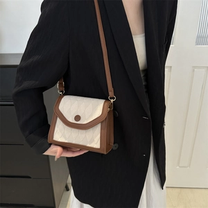 Vintage quilted crossbody bag in beige fabric with brown leather trim and gold hardware