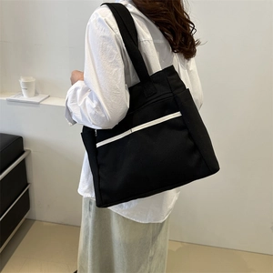 Large black canvas tote bag with white stripe detail for women's daily commute