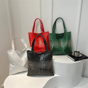 Chic faux-crocodile pattern tote bags in four colors on minimalist display stands