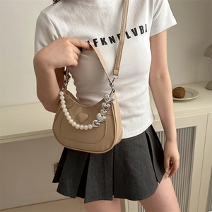 Chic khaki crescent handbag with heart detail and decorative pearl heart chain