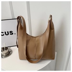 Detailed close-up of khaki brown leather hobo bag featuring golden hardware and wide strap