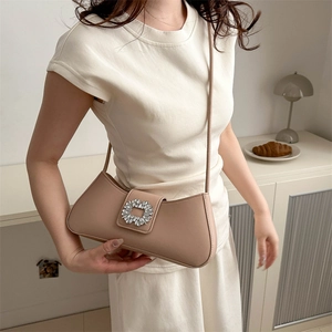 Elegant beige leather underarm bag featuring a sparkling square rhinestone buckle detail