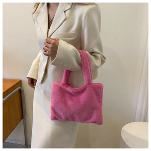 Detail view of the soft pink faux fur texture on this large stylish tote handbag
