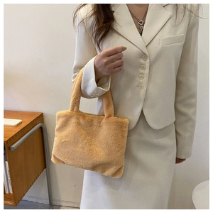 Detail view of light brown plush handbag with soft faux fur texture for women