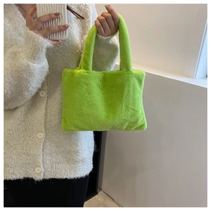Detail of neon green plush tote bag with soft faux fur texture and matching handles