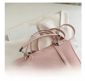 Detail of pink marble pattern PU leather bag with gold rings and fine stitching