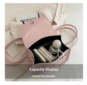 Top view of pink leather handbag interior showing large capacity for phone and wallet
