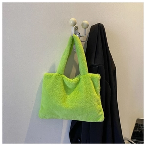 Detailed view of neon green plush faux fur tote bag hanging with minimalist stylish texture