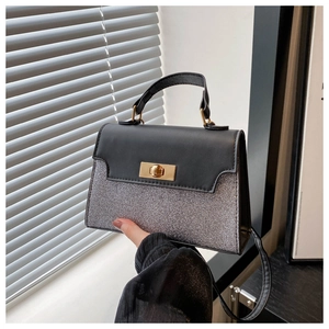 Close-up of dual-texture mini bag with black matte leather and silver glitter finish