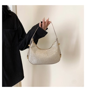 Detailed shot of sequined champagne hobo bag with adjustable gold metallic buckle