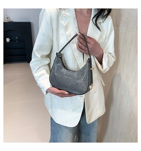 Detailed shot of sparkling silver sequin hobo bag with sleek zipper and gold buckle