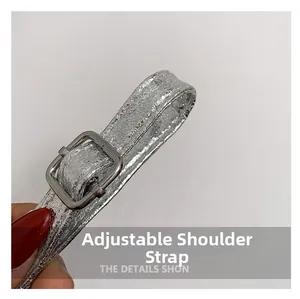 Macro detail of silver cracked leather adjustable shoulder strap with metal buckle