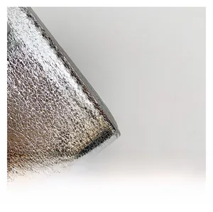 Detail of silver textured leather handbag base with protective metal studs