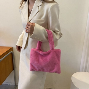 Minimalist rose pink plush tote bag with soft faux fur texture and sturdy top handles