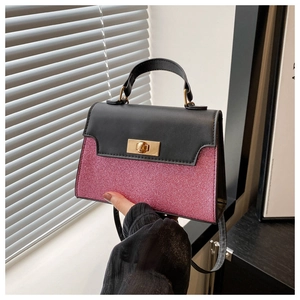 Detail view of pink glitter texture and golden twist lock on a shoulder bag