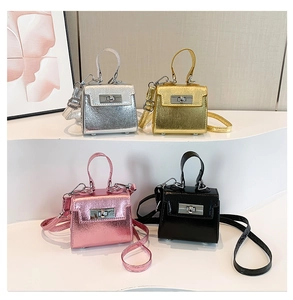 Group of mini metallic crossbody bags in silver, gold, pink, and black on white steps
