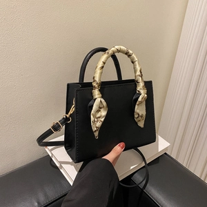 Chic black square tote bag with silk scarf handle and detachable shoulder strap