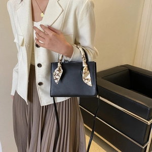 Chic black leather square handbag with silk scarf handle and adjustable shoulder strap