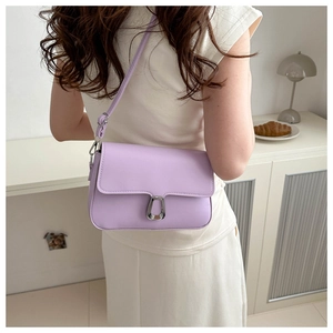 Lifestyle shot of light purple square crossbody bag with silver U-shaped buckle on model