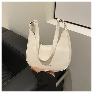 Detail of cream-white crescent underarm bag with litchi grain texture and logo