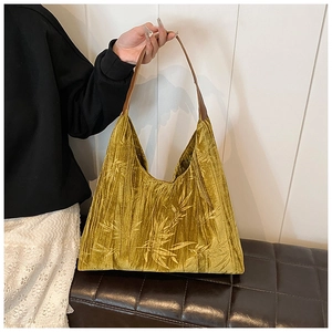 Detailed view of the mustard yellow velvet fabric featuring traditional bamboo patterns