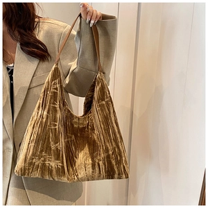 Detail of embossed velvet shoulder bag with bamboo leaf pattern on vintage bronze fabric