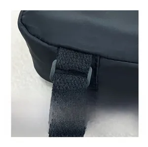 Detail of adjustable nylon strap ring and secure black zipper on kids belt bag