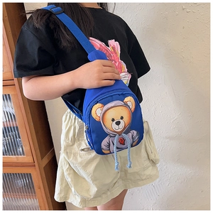 Close-up of blue kids crossbody bag with 3D teddy bear design and adjustable strap