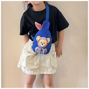 Blue canvas kids chest bag with bear print shown on child model with adjustable strap